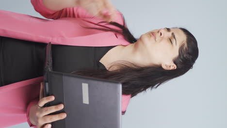 Vertical-video-of-Business-woman-looking-at-laptop-getting-frustrated.-Sad-and-helpless.